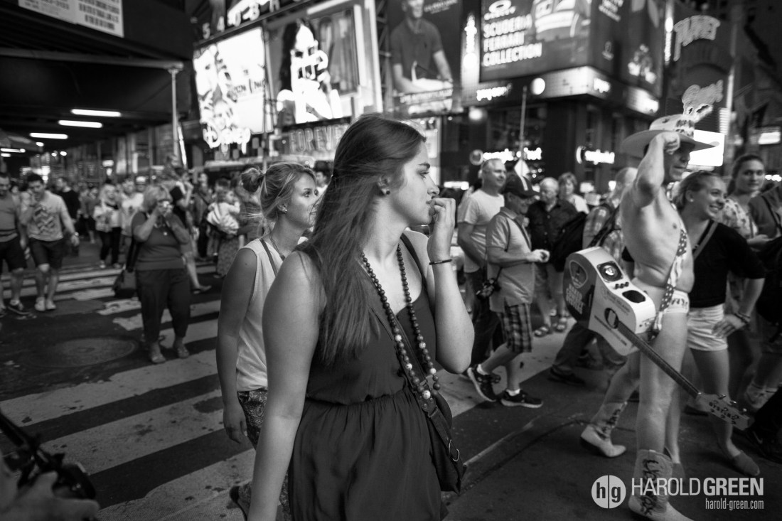 "Sneaking A Glance" Times Square, New York City © 2014 Harold Green.